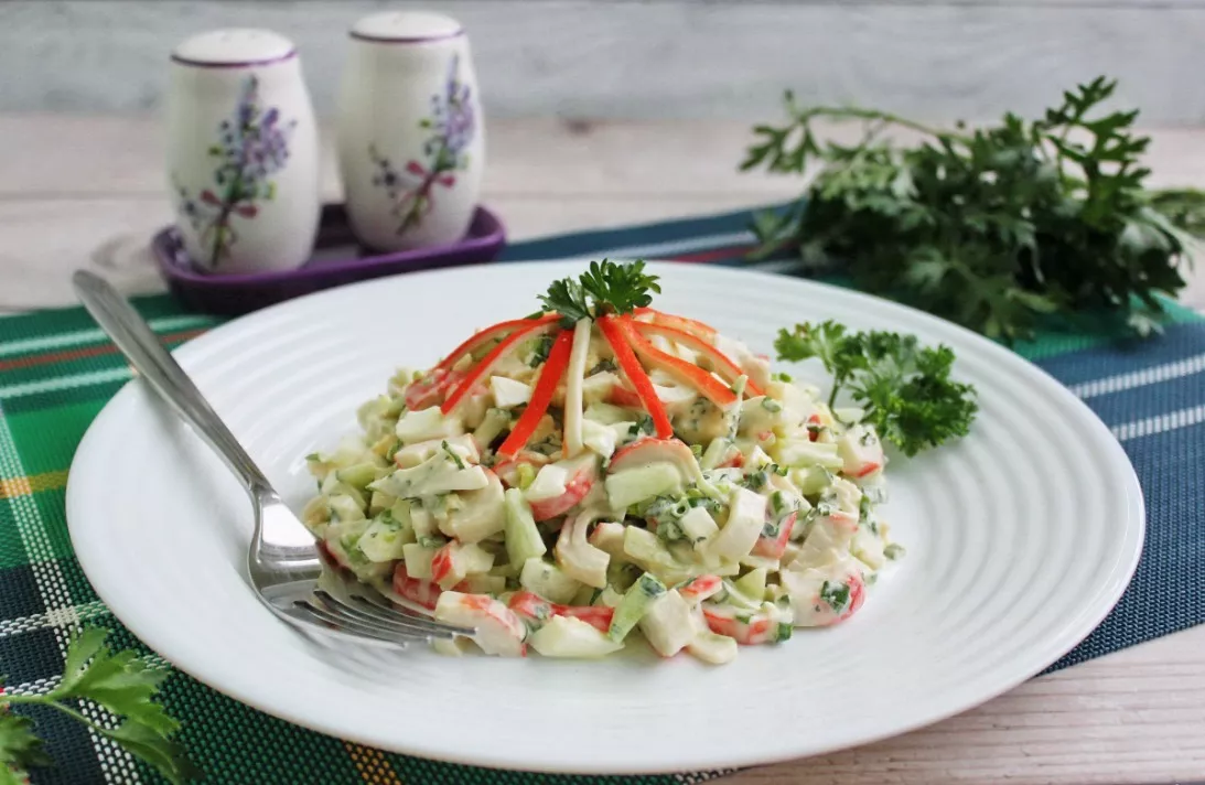 Crab stick salad with onions and herbs