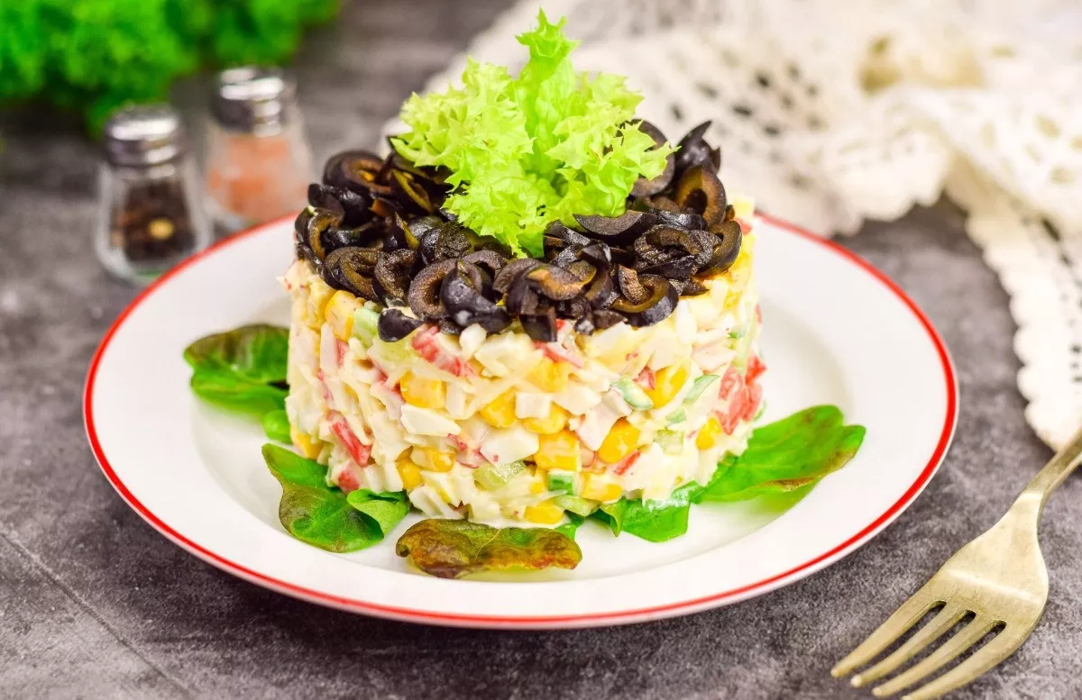 Crab salad with cheese and olives