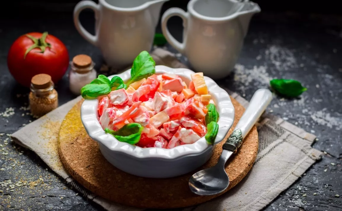 Salad of cheese, tomato and crab sticks