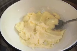 Soften the butter and mash it with half the sugar.