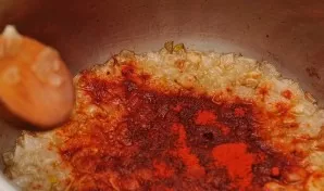 In a saucepan in oil, fry the chopped onion until light golden. Stir in the paprika.