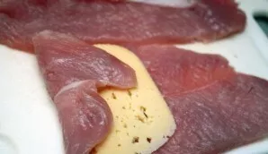 We cut the turkey breast lengthwise into thin layers, then knock it out so that the layers are very thin and flexible. Wrap a small piece...