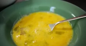 Cut each mozzarella cheese stick in half to get 32 sticks. Pour flour into a bowl. In a separate bowl, beat the eggs and milk.