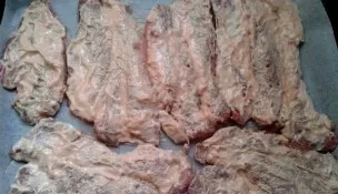 Cut the pork into portions, beat a little, sprinkle with salt and pepper. In a separate bowl, mix ketchup and mayonnaise and brush the me...