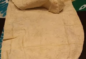 I take out a thin Armenian lavash from the package, stretch it out on the table, fold one part.