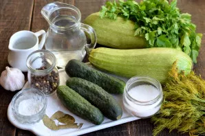 Prepare vegetables and spices for pickling. Wash cucumbers and zucchini thoroughly.