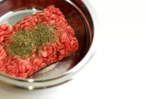 Place the filling in a convenient container. Add salt, pepper, marjoram, three tablespoons of milk and mix well.