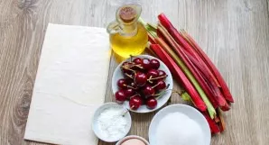 Prepare all the ingredients needed to make the rhubarb and cherry pie. Thaw the dough in advance, wash the cherries and rhubarb.