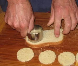 Dry the bread a little in a pan or oven. We cut circles out of it, or cut them into squares.