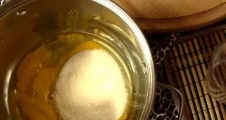 To prepare the cream, break the eggs into a deep saucepan, add sugar. Whip until foamy.