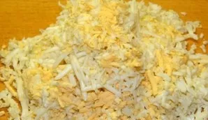 Boil the eggs hard. Cool and grate.