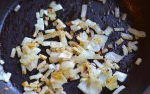 Turn on the oven and preheat to 200 degrees. Chop the onion and fry in a pan until golden brown.