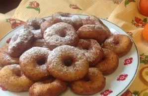 Sprinkle the cooled donuts with powdered sugar.