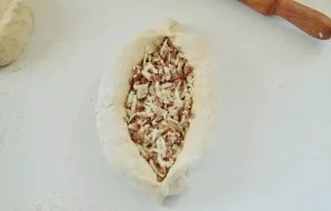 Pinch to the center and open the middle, pushing the edges. Add more filling.