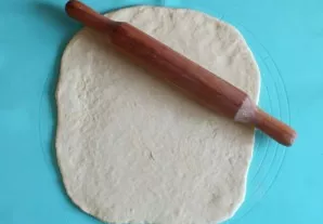 Lightly sprinkle the work surface with flour. Remove the dough from the refrigerator and divide in half. Roll out each part into a layer ...