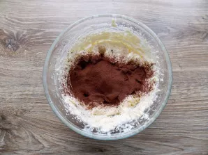 Sift cocoa through a fine sieve into whipped butter.