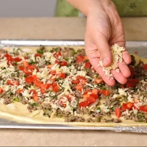 Add half of the chopped tomato and grated cheese.