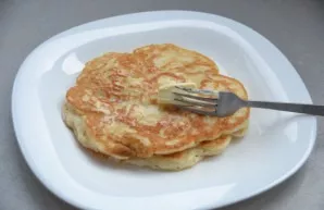 Fry the pancakes in a preheated pan on both sides, pre-anointing with vegetable oil. Lay out the finished pancakes in a pile, grease the ...