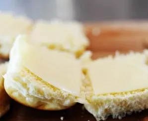 Put a piece of cheese on each part of the bun.