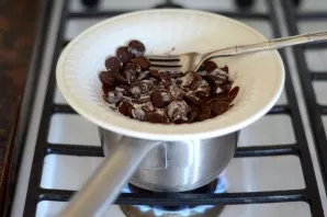 Melt the chocolate in a water bath, add a tablespoon of heavy cream.