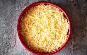 Spread the remaining half of the grated cheese in an even layer on the surface of the curd mass. Put the casserole to bake in an oven alr...