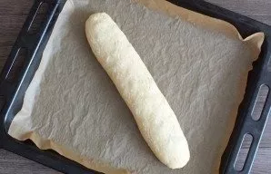 Transfer the resulting roll to a baking tray. Brush it with beaten egg and scratch it with a fork to create a wavy pattern. This is optio...