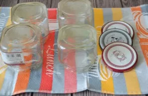 Prepare jars for dressing, rinse them with soda, sterilize jars and lids, pour hot ketchup into them.