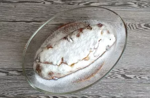 While the cake is still hot, grease it well with butter. Sprinkle generously with powdered sugar immediately.