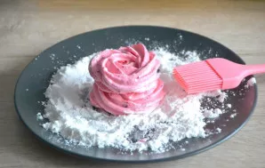 Put two at a time, roll the marshmallows in powdered sugar. Wipe off excess powder.