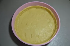 Put the dough in a mold, having previously rolled it into a layer and transferred to the mold, form the sides, beat the bottom with a for...