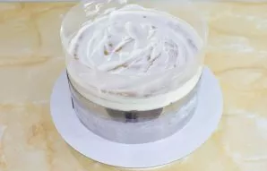 Wrap the cake with acetate film and tighten into a ring. Press the upper crust so that the filling inside is distributed more evenly. Put...