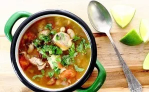 Chop the coriander and put it in soup bowls. We also serve lime to the soup, its juice will give the soup a little sourness.