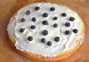 Place the other patty on top and spread it with white cream, you can add any berries or pieces of fruit. This recipe uses frozen blueberr...