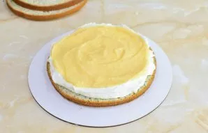 Biscuits can be soaked in sugar syrup or water. Put the first layer of biscuit and coat it with cream, forming small sides on the sides. ...