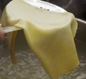 Carefully remove the lasagna sheets from the boiling water and let them cool slightly.