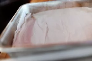 Now we take the prepared puff pastry, roll out and line the baking sheet with a thin layer of dough. Before that, the form must be anoint...