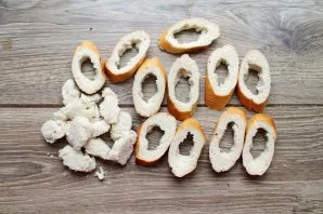 Cut the baguette diagonally and remove the middle.