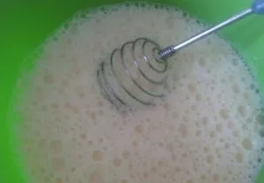 Pour in the milk and whisk and stir.