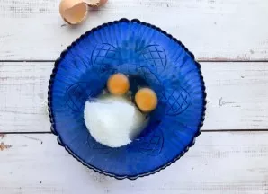 Break eggs into a deep bowl, add sugar and beat well with a mixer or whisk.