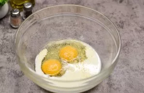 Break a few eggs into a bowl, add milk, salt and pepper to taste. If desired, add a little dried garlic.