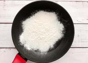Add the sifted flour to the dry pan.