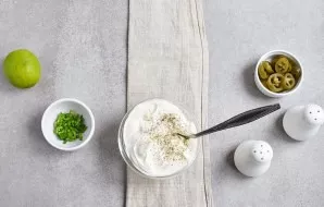 Mix mayonnaise with sour cream, salt to taste and sprinkle with black pepper. Stir.