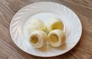 Cook the eggs after boiling for 12 minutes. Pour cold water over the eggs, cool and peel. Cut the bottom of the egg from the wide side an...