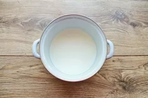 Bring the milk to a boil and remove from heat, cool until warm. Add natural yogurt and mix.