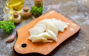 Peel the onion, wash and dry it, cut into half rings.