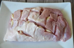 In a piece of ham, make incisions and stuff them with garlic.