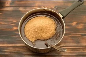 Remove the chocolate mass from the heat and add sugar to it, mix well. No need to wait for the sugar to dissolve.