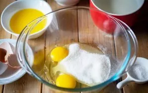 Break the eggs into a large bowl and add sugar.