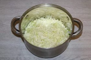 Chop the cabbage into long strips. Put in a saucepan with a thick bottom.