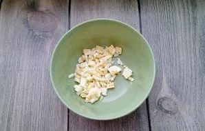 Boil the eggs hard, cool, peel and chop finely. Put in a bowl.